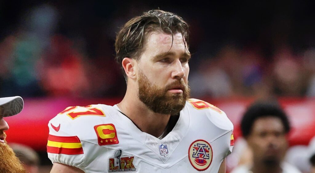 Travis Kelce looking on.