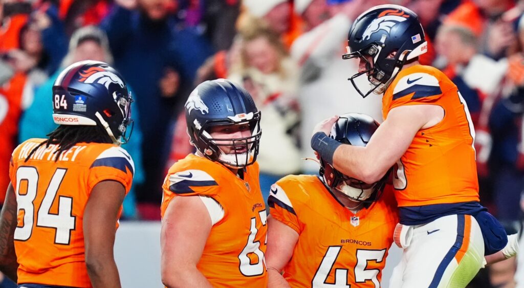 Denver Broncos celebrating a touchdown. A trade proposal has them getting D.K. Metcalf.